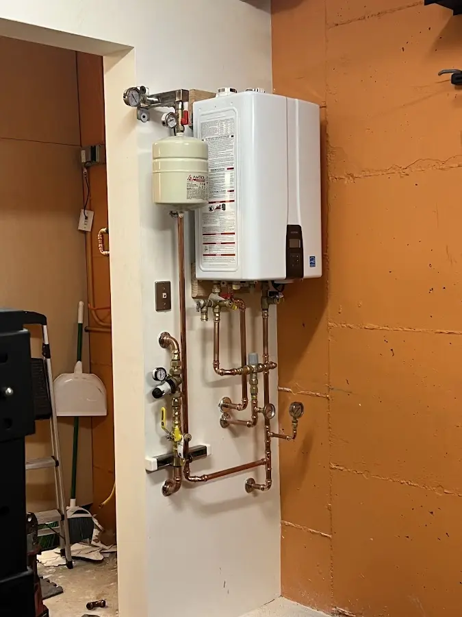 Plumbing technician inspecting water heater connections in Lexington